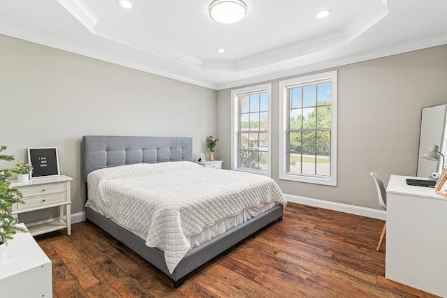 bedroom featuring a raised ceiling, dark hardwood / wood-style flooring, and ornamental molding