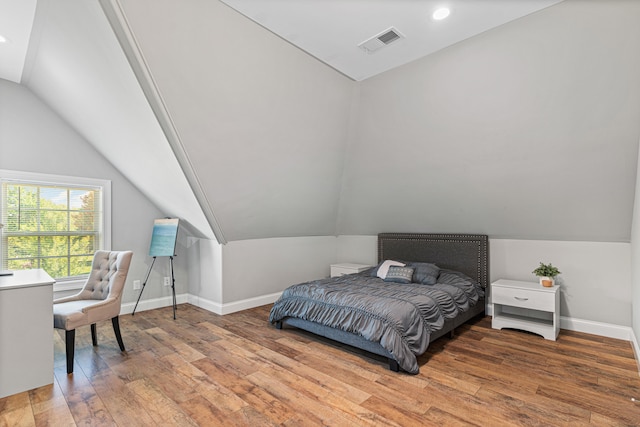 bedroom with wood-type flooring and lofted ceiling