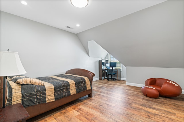 bedroom featuring hardwood / wood-style flooring and vaulted ceiling