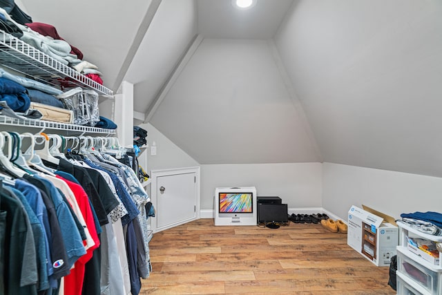 spacious closet with wood-type flooring and lofted ceiling