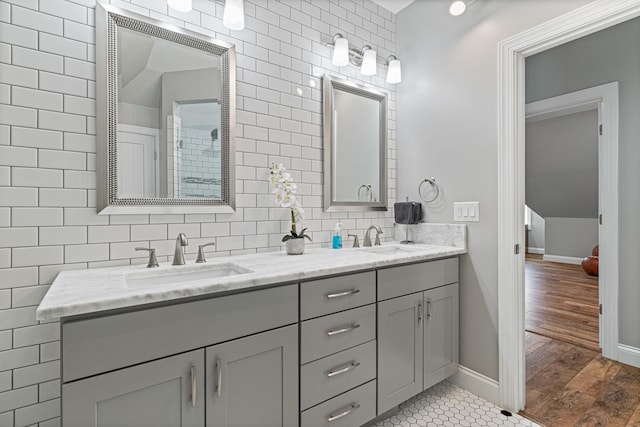 bathroom featuring vanity, hardwood / wood-style flooring, and tile walls