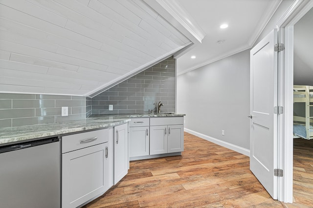 kitchen featuring crown molding, sink, decorative backsplash, light stone countertops, and light hardwood / wood-style floors