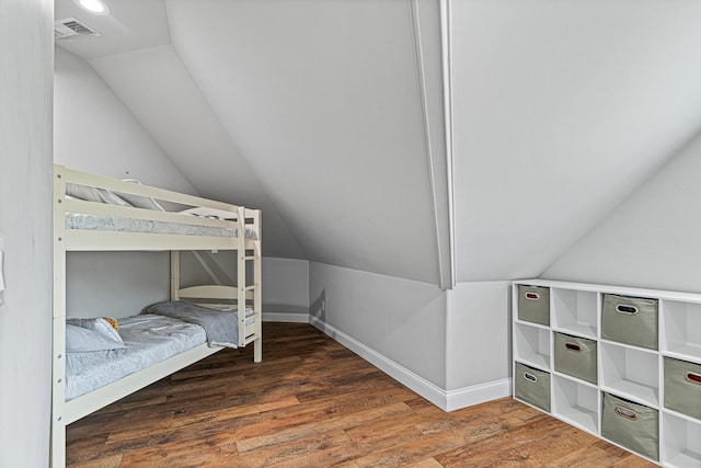 bedroom featuring dark hardwood / wood-style flooring and vaulted ceiling