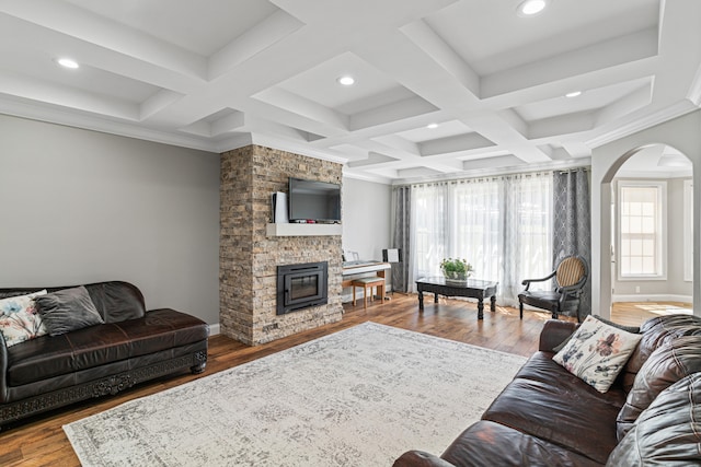 living room featuring wood-type flooring, coffered ceiling, and beam ceiling