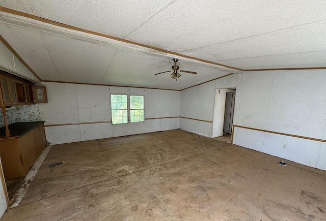 empty room with ceiling fan and lofted ceiling