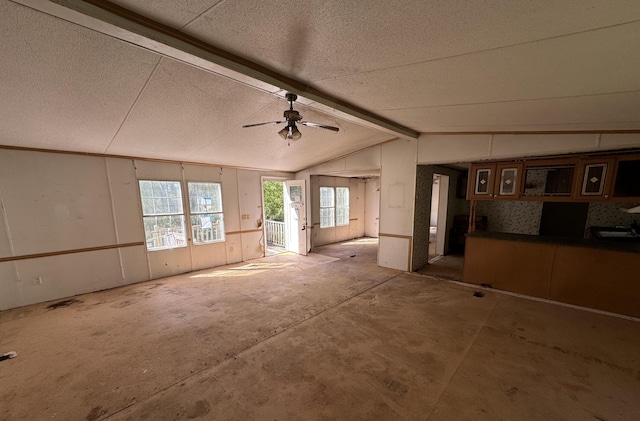 miscellaneous room with ceiling fan, lofted ceiling with beams, and a textured ceiling