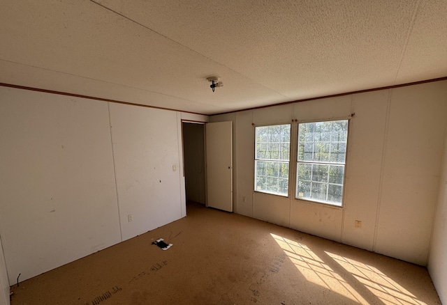 spare room featuring a textured ceiling