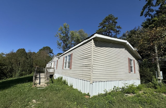 view of property exterior featuring a lawn