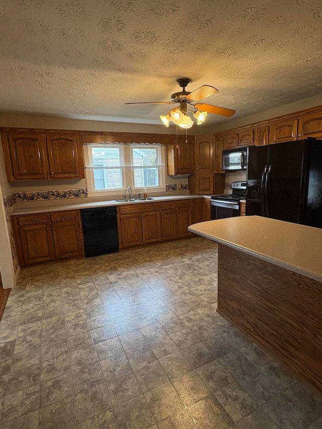 kitchen featuring black appliances, ceiling fan, sink, and a textured ceiling