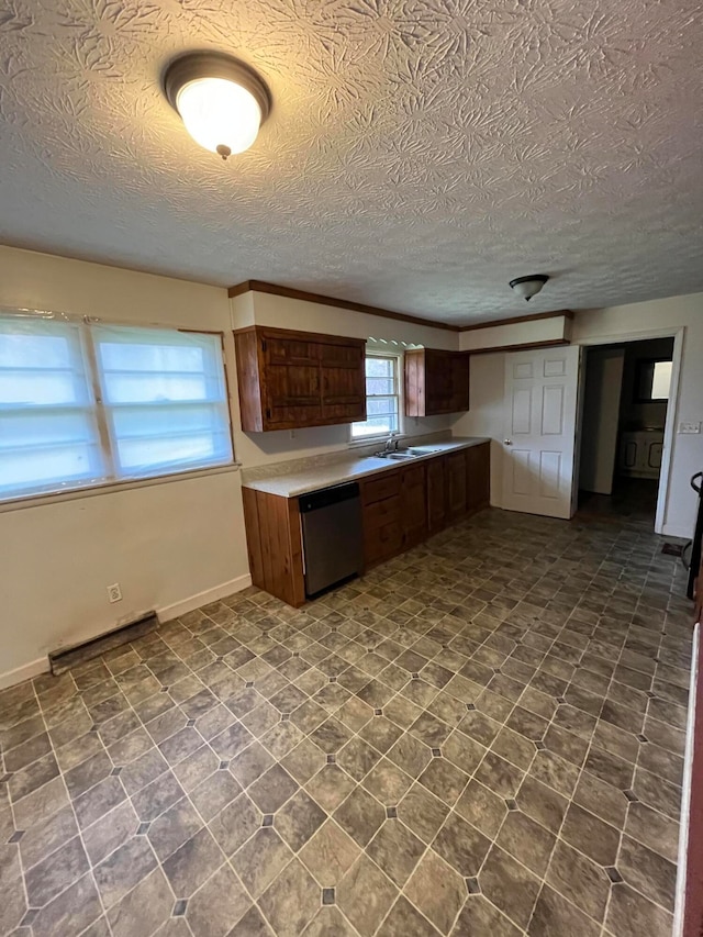 kitchen featuring sink, stainless steel dishwasher, and a textured ceiling