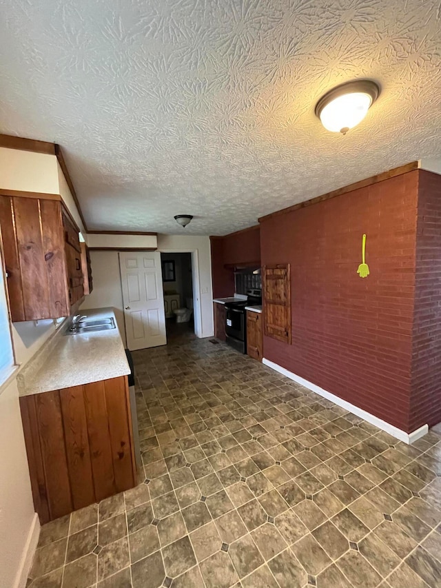 kitchen with sink, a textured ceiling, and black range with electric cooktop