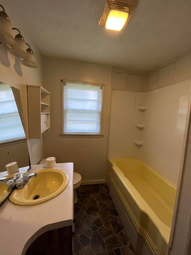 full bathroom featuring bathing tub / shower combination, vanity, a textured ceiling, and toilet