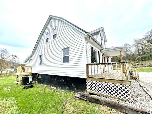 view of side of property with a yard and cooling unit