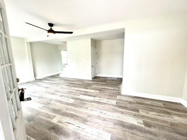 spare room with hardwood / wood-style flooring and ceiling fan