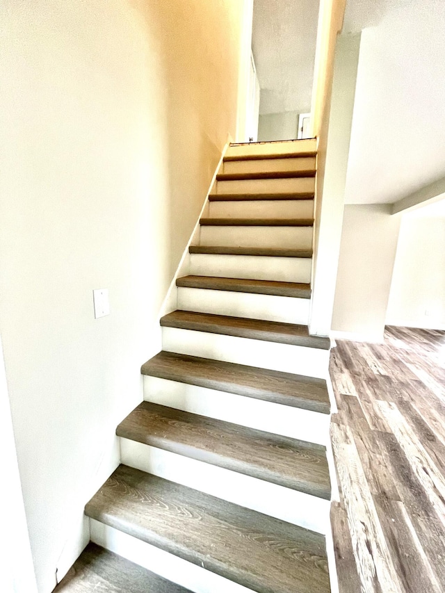 staircase featuring hardwood / wood-style flooring