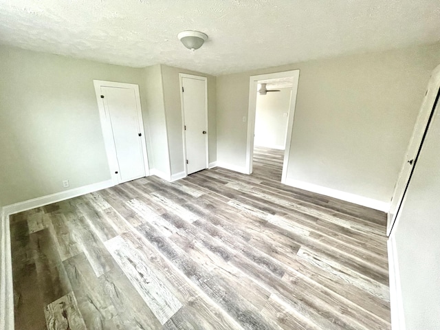 unfurnished bedroom featuring a textured ceiling and hardwood / wood-style flooring