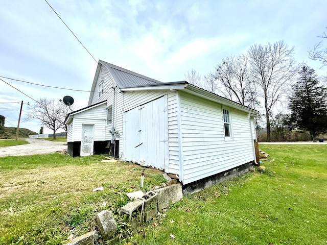 view of side of home featuring a yard