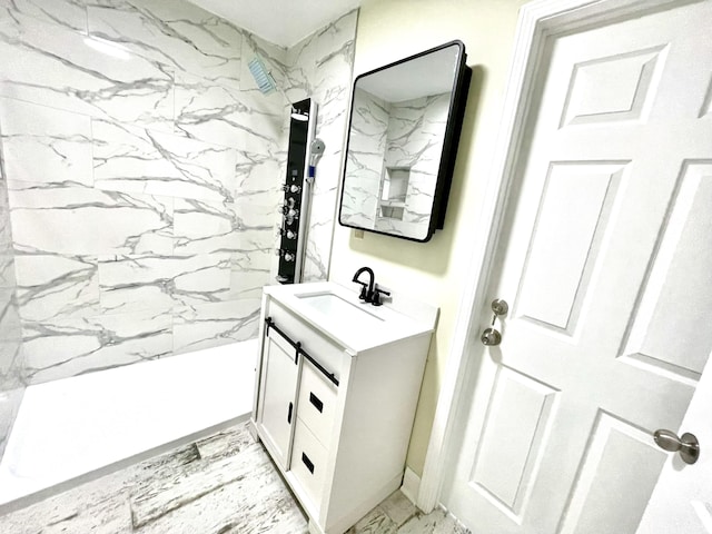 bathroom featuring a tile shower and vanity