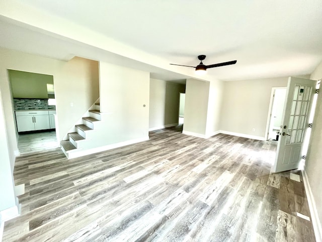 unfurnished living room with light hardwood / wood-style floors and ceiling fan