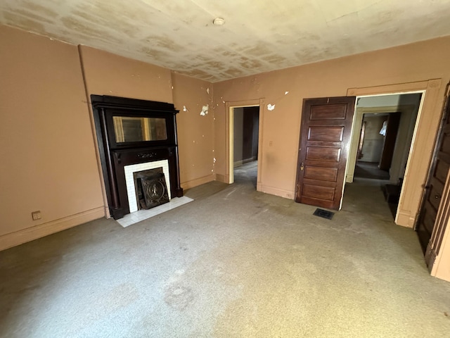 unfurnished living room featuring light carpet