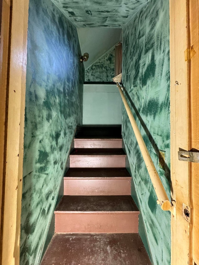 stairway featuring vaulted ceiling