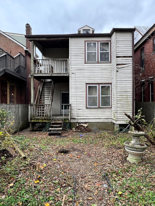 back of house featuring a balcony