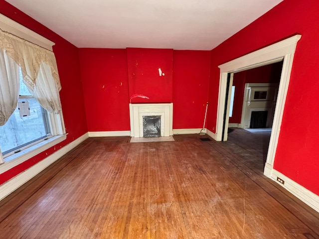 unfurnished living room featuring dark hardwood / wood-style flooring