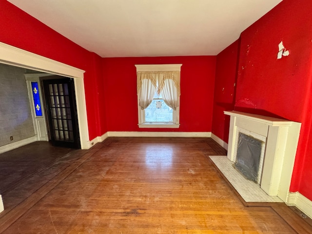 unfurnished living room featuring wood-type flooring