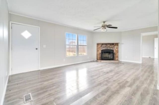 unfurnished living room with ceiling fan, light hardwood / wood-style flooring, and ornamental molding