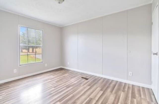 unfurnished room featuring light hardwood / wood-style flooring