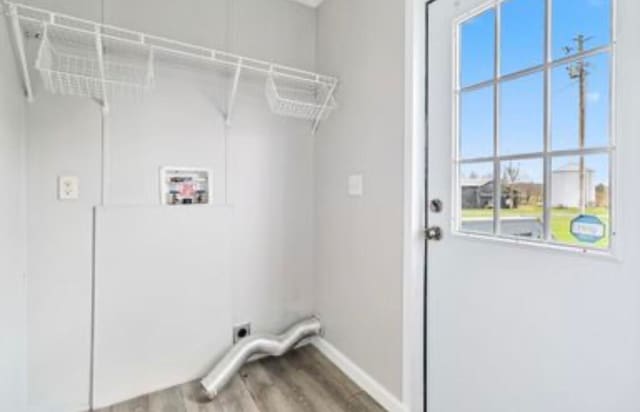 laundry area featuring hardwood / wood-style floors, electric dryer hookup, hookup for a washing machine, and a wealth of natural light