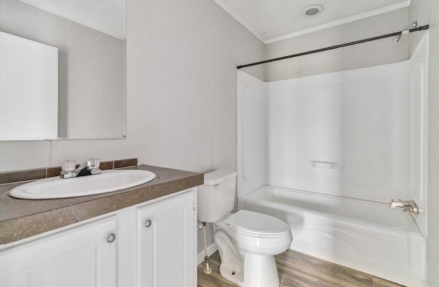 full bathroom featuring shower / washtub combination, vanity, wood-type flooring, and toilet