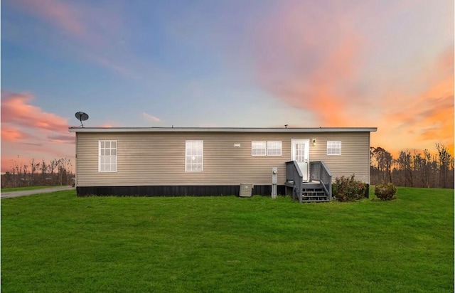 back house at dusk with a yard