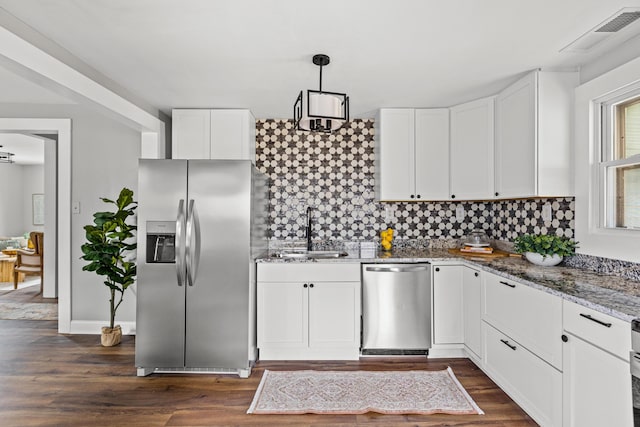 kitchen featuring white cabinetry, sink, stainless steel appliances, dark hardwood / wood-style floors, and pendant lighting