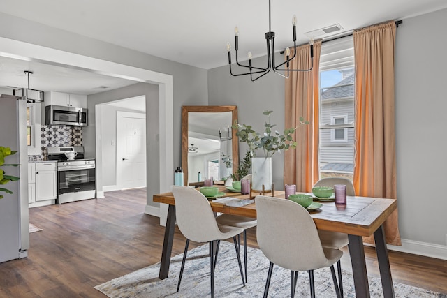 dining area featuring a chandelier and dark hardwood / wood-style flooring