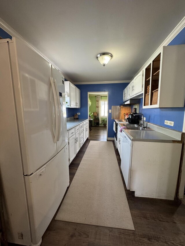 kitchen with dark hardwood / wood-style floors, white cabinetry, ornamental molding, and sink