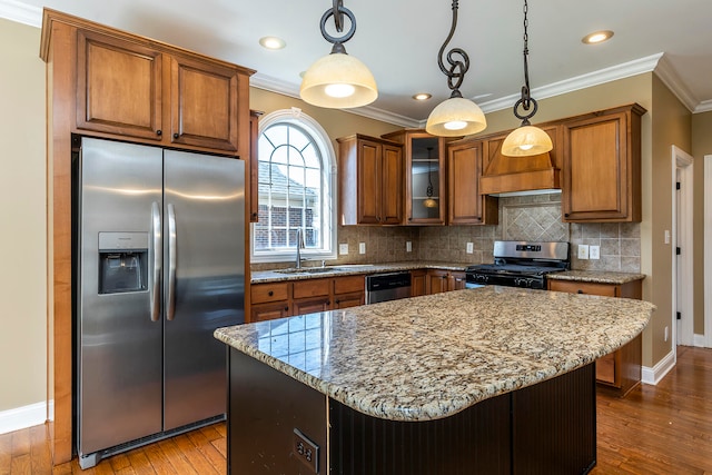 kitchen featuring appliances with stainless steel finishes, pendant lighting, and wood-type flooring