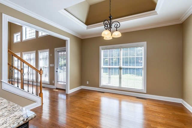 interior space with plenty of natural light, wood-type flooring, and an inviting chandelier