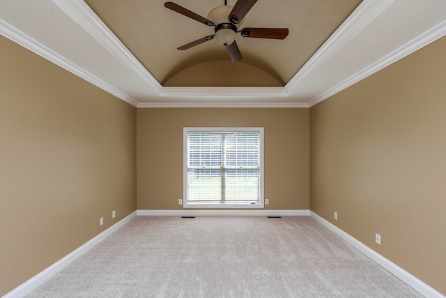 carpeted empty room featuring ceiling fan, a raised ceiling, lofted ceiling, and crown molding