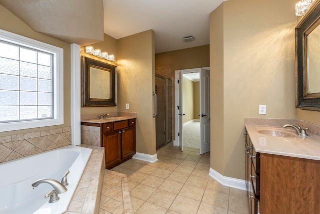 bathroom featuring shower with separate bathtub, vanity, and tile patterned floors