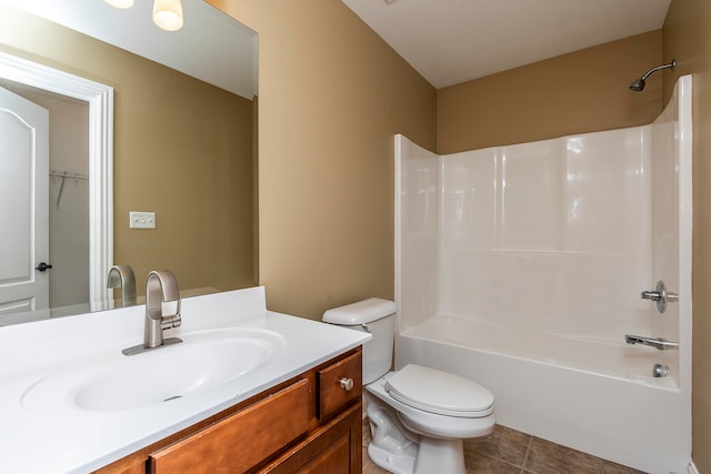 full bathroom with shower / bathing tub combination, tile patterned flooring, vanity, and toilet