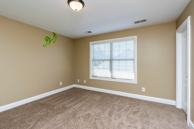 unfurnished room with light carpet