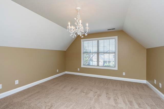 bonus room featuring lofted ceiling, light carpet, and an inviting chandelier