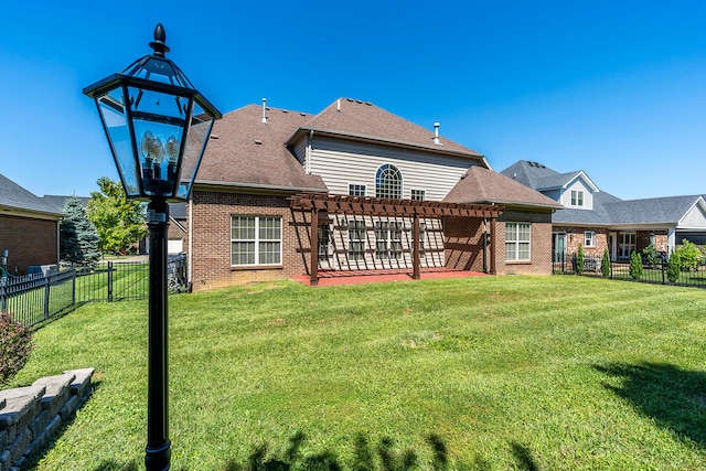 rear view of house featuring a pergola and a lawn