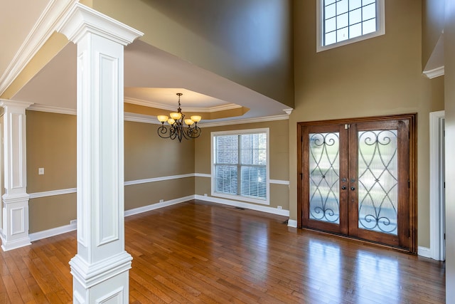 entrance foyer featuring a chandelier, wood-type flooring, and ornamental molding