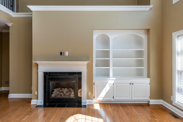 interior details featuring wood-type flooring and crown molding