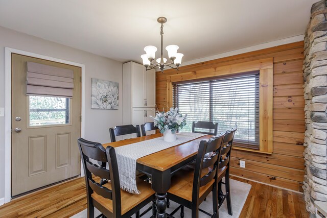 unfurnished bedroom featuring ceiling fan, hardwood / wood-style floors, ensuite bath, and multiple closets