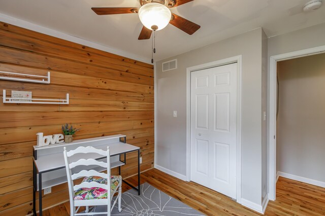 spare room with wood-type flooring and wooden walls