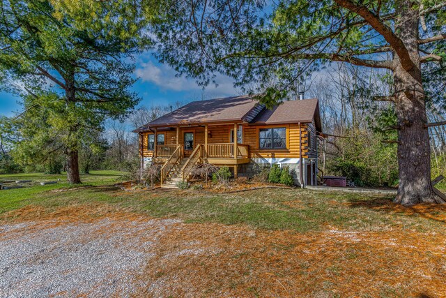 log home with a front yard and a porch