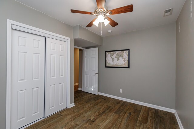 basement with ceiling fan and a wood stove